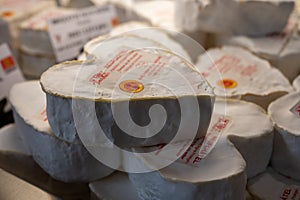 French heartshaped neufchatel cow cheese for sale in farmers dairy shop, french text on lables means Neufchatel cheese, made from