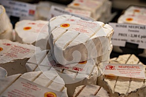 French heartshaped neufchatel cow cheese for sale in farmers dairy shop, french text on lables means Neufchatel cheese, made from