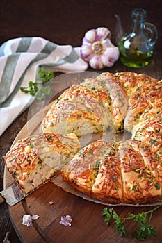 French homemade sourdough white bread with garlic, grated cheese, olive oil and parsley