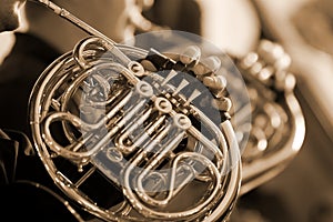 French horn in the hands of the musician