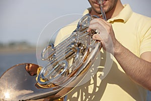 French horn instrument. Player hands playing horn music brass instrument
