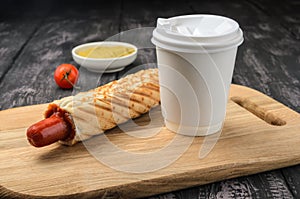 French Hot Dog and coffee on wooden table