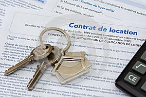 French housing rental contract empty rental lease. Close-up shot with a bunch of keys and a calculator
