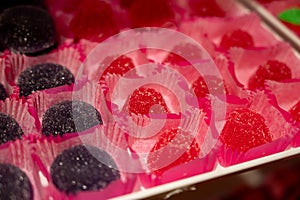 French or italian sweets, fruit jelly bonbons on display in confectionery shop in Milan, Italy close up