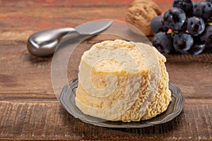 French Langres soft cows crumbly cheese with washed rind structure made in Champagne - Ardenne region photo