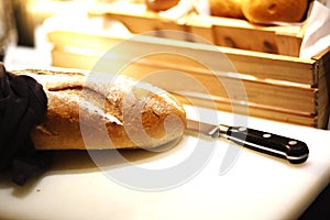 French loaf on breadboard