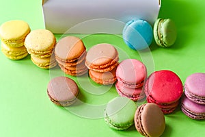 French macarons over a green background