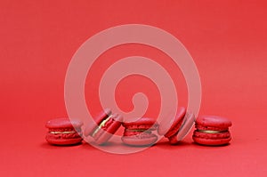 French macaroons cookie stack on red backgrouds photo