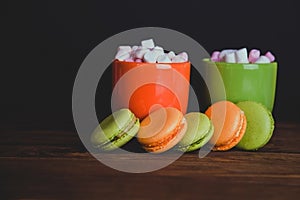 French macaroons and marshmellow in dark colours