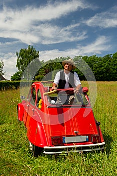 French man with his typical red car