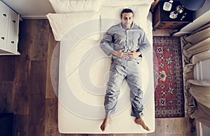 French man sleep alone on bed