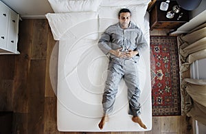 French man sleep alone on bed