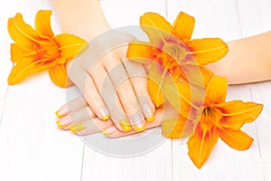 French manicure with orange lily. spa