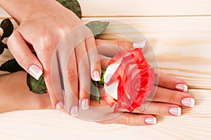 French manicure and red rose