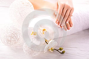 French manicure and wnite orchid flower