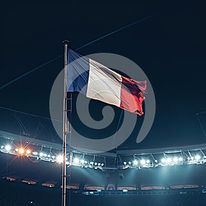 The French national flag flutters at dusk against the backdrop of famous Sunset Stadium, Summer Olympics in Paris 2024