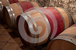 French oak wooden barrels for aging red wine in underground cellar, Saint-Emilion wine making region picking, cru class Merlot or