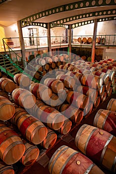 French oak wooden barrels for aging red wine in underground cellar, Saint-Emilion wine making region picking, cru class Merlot or