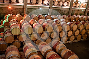 French oak wooden barrels for aging red wine in underground cellar, Saint-Emilion wine making region picking, cru class Merlot or