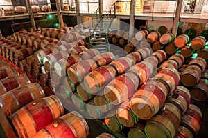 French oak wooden barrels for aging red wine in underground cellar, Saint-Emilion wine making region picking, cru class Merlot or