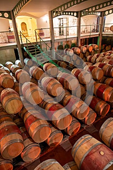 French oak wooden barrels for aging red wine in underground cellar, Saint-Emilion wine making region picking, cru class Merlot or