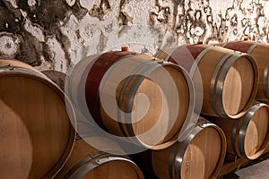 French oak wooden barrels for aging red wine in underground cellar, Saint-Emilion wine making region picking, cru class Merlot or