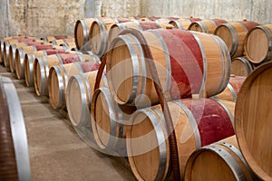 French oak wooden barrels for aging red wine in underground cellar, Saint-Emilion wine making region picking, cru class Merlot or