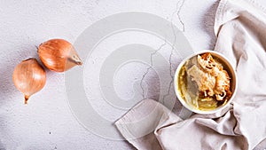 French onion soup with baked cheese bread in a bowl on the table top view web banner