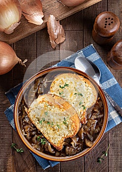 French onion soup with toasted cheese baguette garnished with thyme