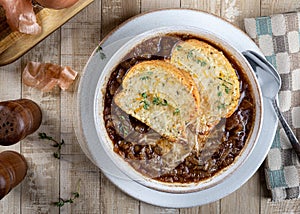 French onion soup with toasted cheese baguette garnished with thyme