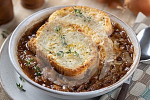 French onion soup with toasted cheese baguette garnished with thyme