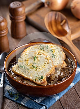 French onion soup with toasted cheese baguette garnished with thyme