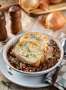 French onion soup with toasted cheese baguette garnished with thyme