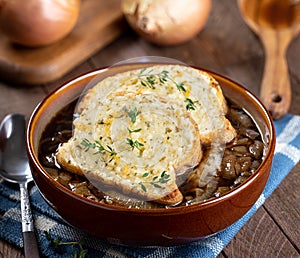 French onion soup with toasted cheese baguette garnished with thyme