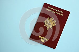 French passport on blue background close up