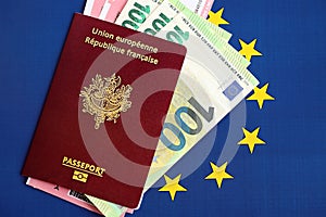 French passport of European Union and airlines tickets with money on blue flag background