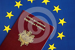 French passport of European Union on blue flag background close up. Tourism and citizenship