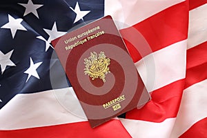 French passport on United States national flag background close up. Tourism and diplomacy