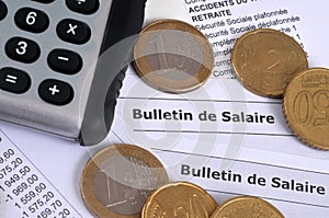French pay slips with euros and calculator close-up
