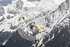 Parapenters flying over french snowy Mont Blanc massif photo