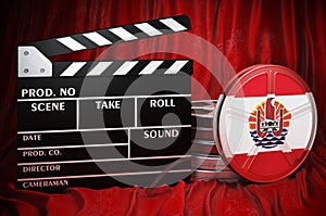 French Polynesian cinematography, film industry, cinema in French Polynesia. Clapperboard with and film reels on the red fabric,