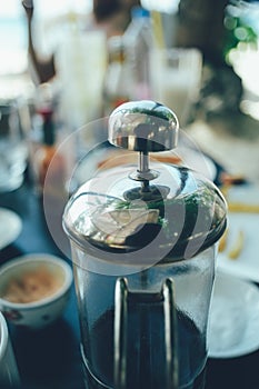 French press coffee maker in a cafe bar. close up image toned image selective focus