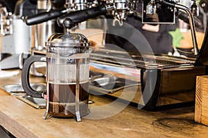 French press coffee pot on table.