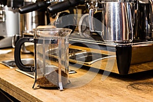 French press coffee pot on table.