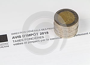 French property tax and heap of euros coins