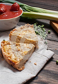 French Quiche Lorraine with ingredients on wood board