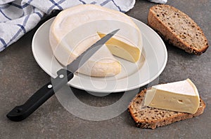 French Reblochon cheese on a plate with a knife