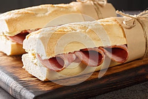 French Sandwich Jambon-Beurre made from a baguette with butter and ham closeup. Horizontal