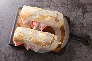 French Sandwich Jambon-Beurre made from a baguette with butter and ham closeup. Horizontal top view