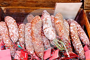 French saucissons and ham display in market in
